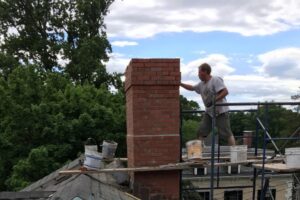 person repointing a chimney