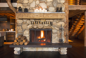 stone fireplace with lit fire